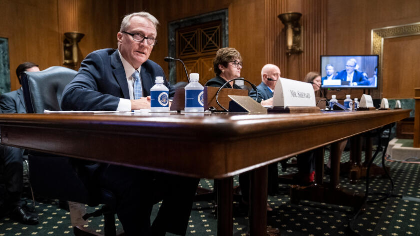 Wide-shot photograph of Brian Shepard seated at a table and testifying in the Senate committee room