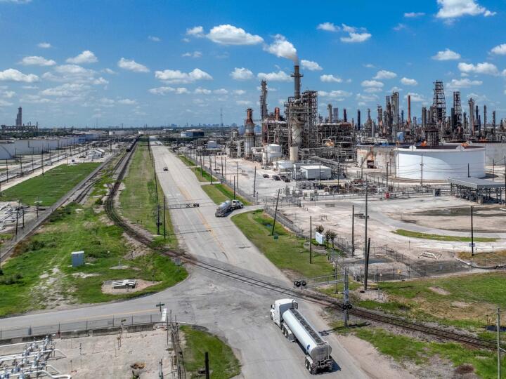 Photograph of an aerial view of an oil refinery on a clear day.