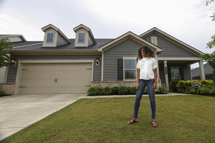 Crystal Marie McDaniels in the yard of her new Charlotte home.